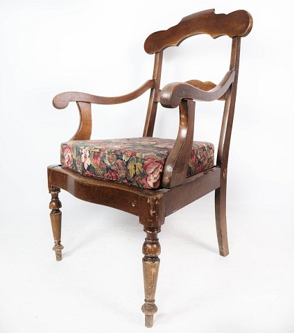 Antique armchair of mahogany and upholstered with floral fabric from the 1880s. 
5000m2 showroom.