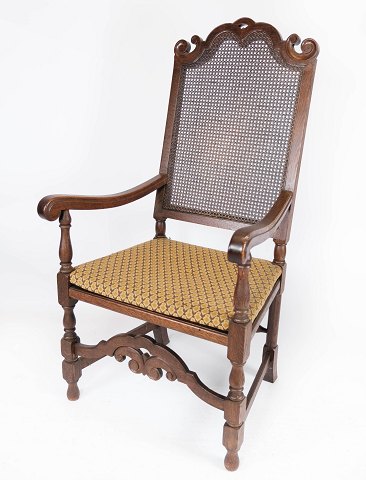 Antik armstol af eg, med original polstring af lyst stof og rørflet, fra 
1920erne.
5000m2 udstilling.