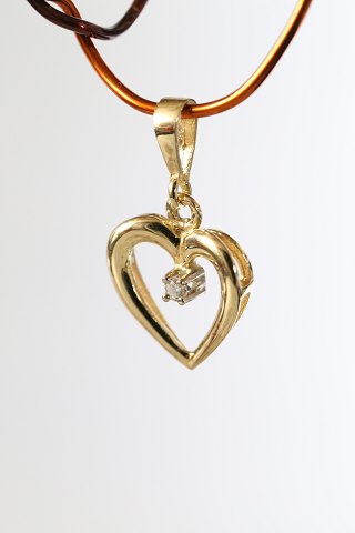 Heart-shaped pendant in 14 carat gold, with a brilliant. Stamped 585. Very 
exclusive.