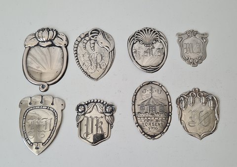 Lot of 8 coat shields in silver