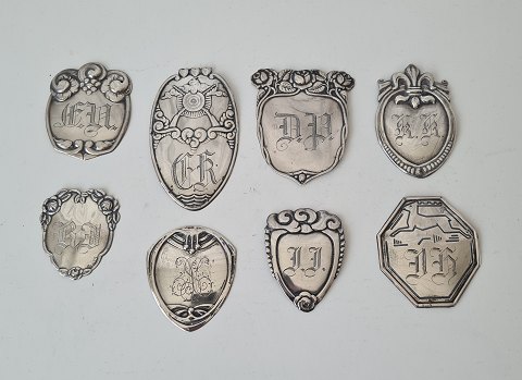 Lot of 8 coat shields in silver