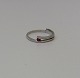 White gold ring in a modern design, made of 14 kt gold adorned with a ruby
