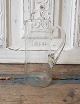 Old mouth-blown glass jug with twisted handle