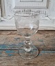 1800s wine glass presumably Aalborg Glasvoork. Wine glass with round basin on 
stem with button, decorated with matted oak leaves with catch wire.
