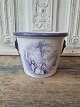 19th century English faience flower pot with lion heads as handle and manganese 
colored decoration