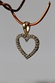 Heart-shaped pendant in 14 carat gold, with diamonds. Stamped 585. Very 
exclusive.