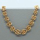 A. F. Rasmussen; A wide necklace of 14k gold, l. 42 cm.