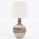 Tue Poulsen / Own workshop
Table lamp in stoneware with a rough surface in earthy colours and white shade.
1 pc. in stock
Original condition
