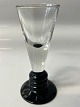Snapseglas på sort fod,Højde:  cm. 10,7 cm.Designet af Jacob E Bang Holmegaard.