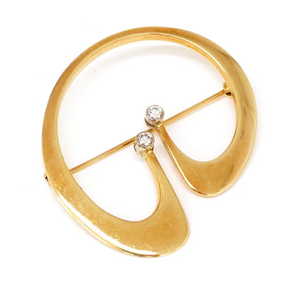 14kt gold gold brooch with two diamonds, circa 0,1ct, by Bent Gabrielsen, 
Denmark. #347. Size: 4x3,8cm