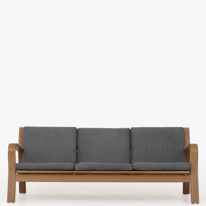 Hans J. Wegner / Getama
GE 671/3 - 3 seater sofa in bent oak and cushions in green wool. Designed in 
1967.
1 pc. in stock
Good, used condition
